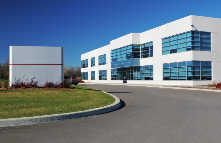 commercial building showing with white structure and tinted windows