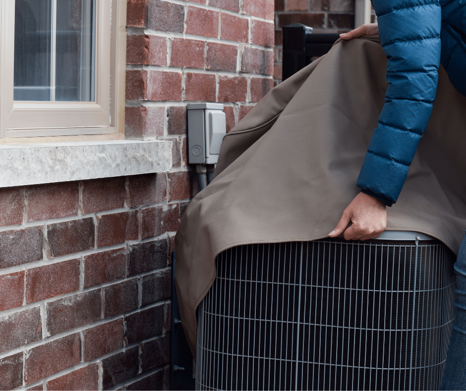 A woman covers her outdoor AC unit with a specialty cover