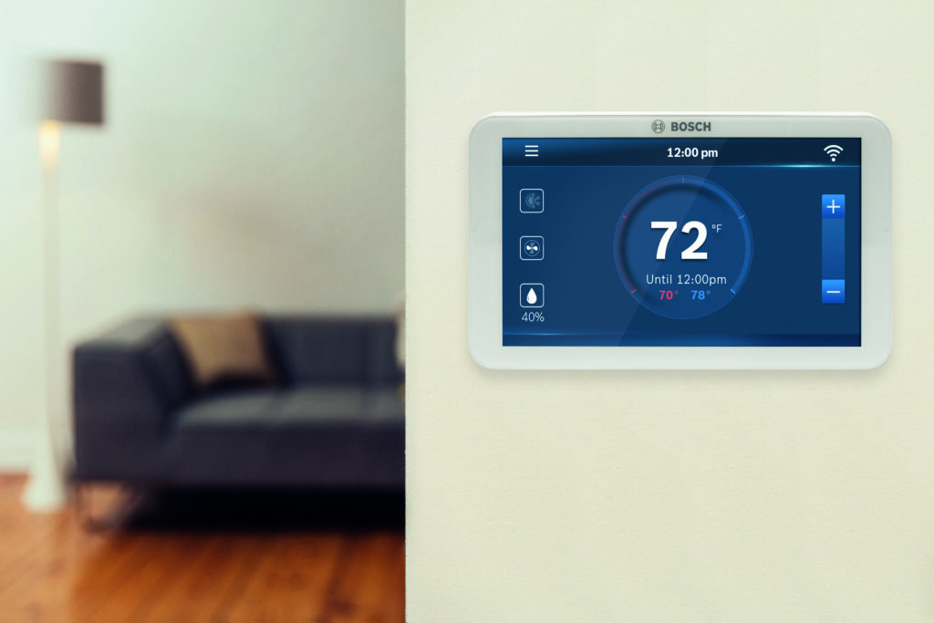 Smart thermostat on residential wall in living room