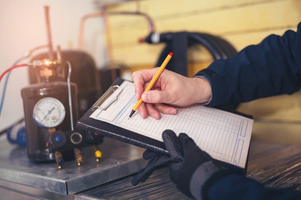 HVAC technician with checklist