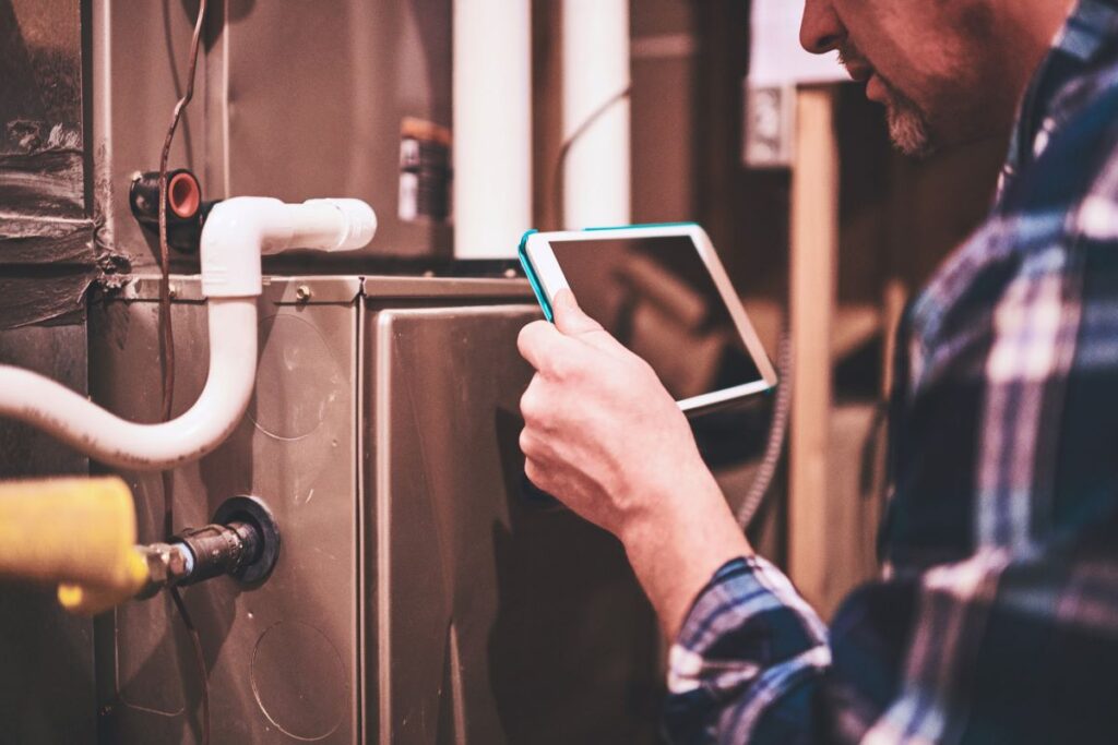 HVAC technician inspecting a furnace