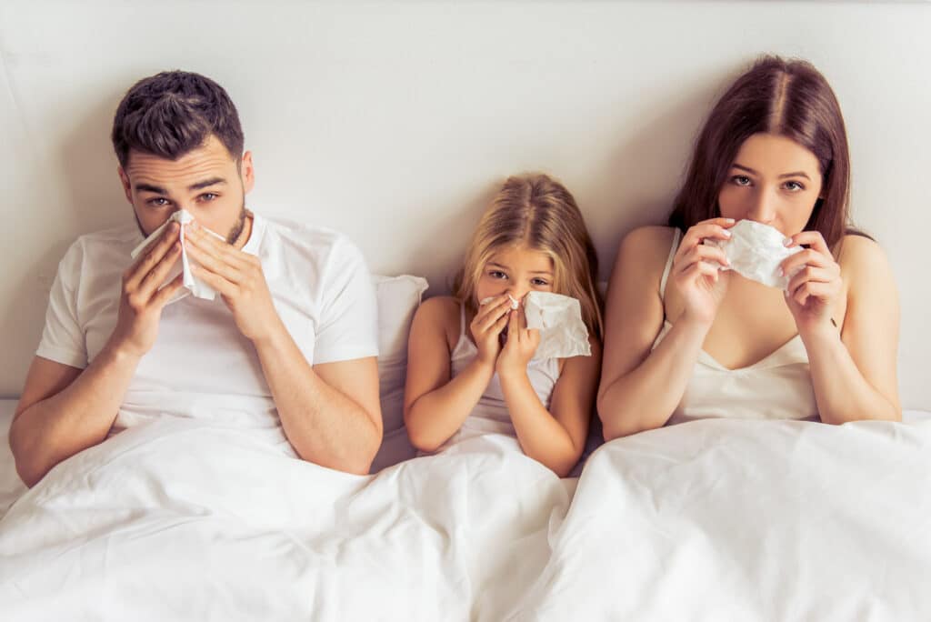 Family with tissues, symptoms of indoor air quality allergies