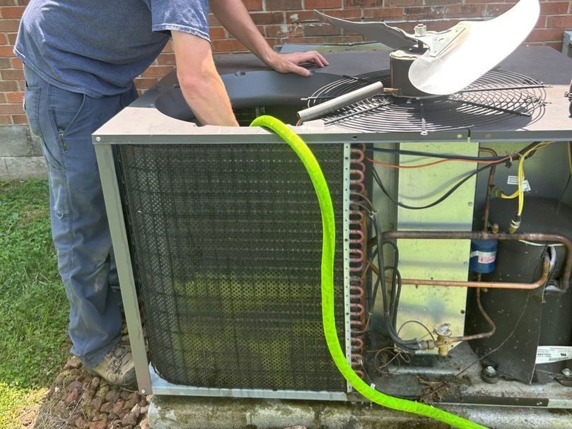 HVAC tech servicing HVAC unit.