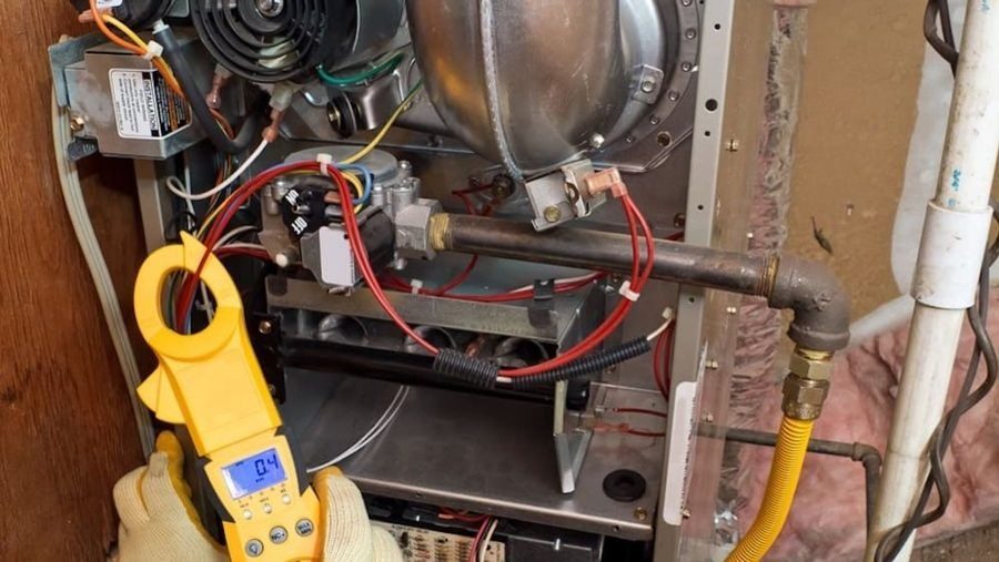 HVAC tech conducting furnace repair.