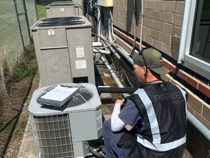 AC units being installed on side of the house.